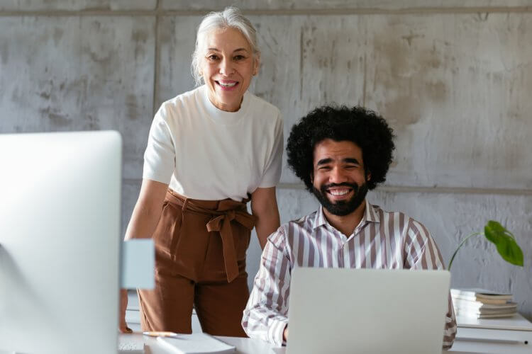 an image of two professionals behind a laptop