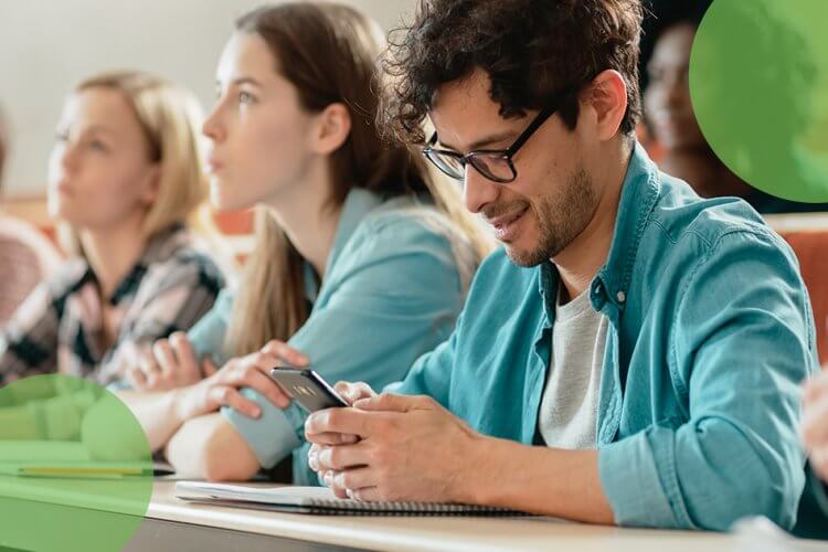 Student at a lecture interacting via smartphone.