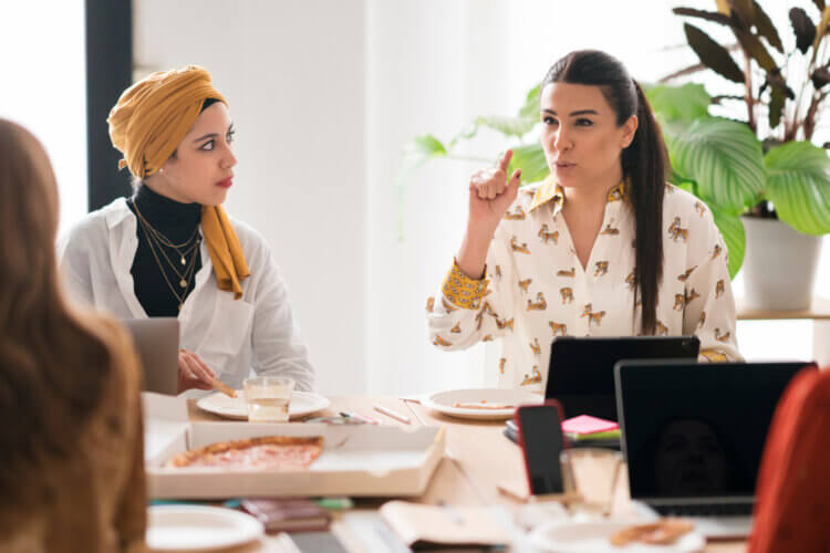 two colleagues at a meeting engaged in a discussion