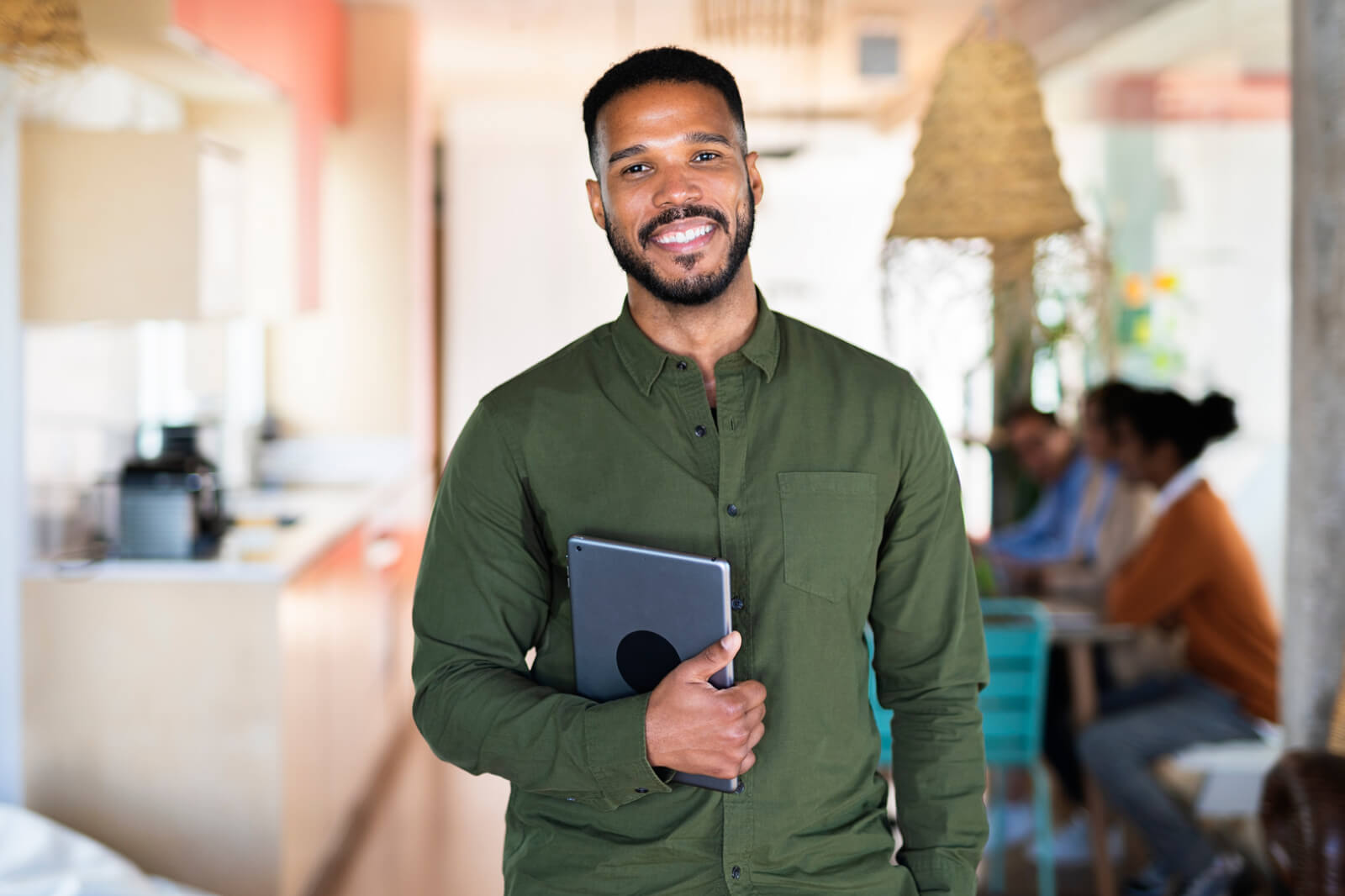 a young male professional with a tablet in a work environment at a meeting