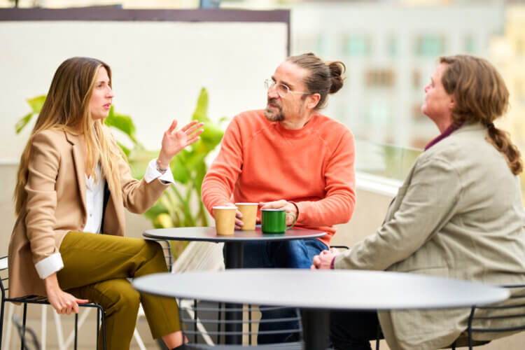 a group of colleagues sitting around a table in the office