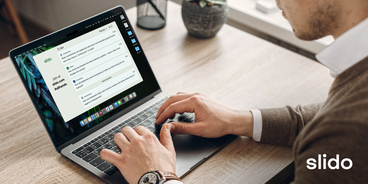 Man at laptop looking at Slido questions